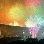 Spectacular fireworks exploding over Beijing's Bird's Nest stadium during the Paralympic opening ceremony, with colorful lights reflecting off the iconic architecture